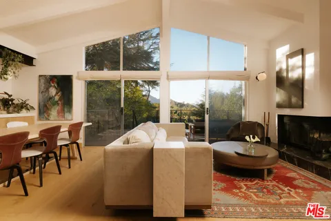 a view of a roof deck with mountain view and wooden floor