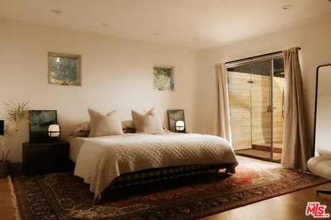 a view of a room with furniture and wooden floor