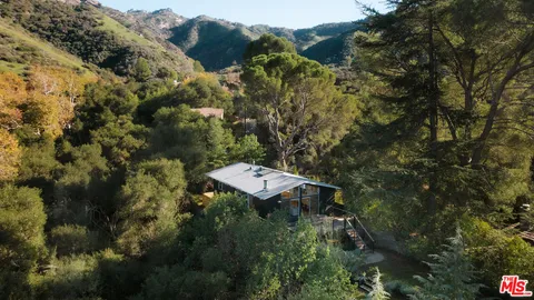 a view of house with a tree