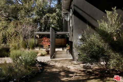 a living room with furniture a large window and a table