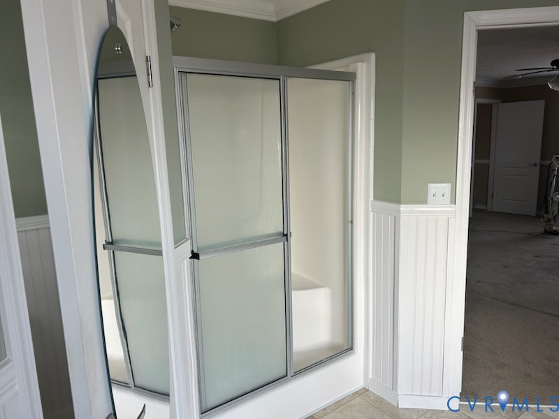 15910 Nobles Road Disputanta, VA 23842 - Photo 33 of 38 Bathroom with wainscoting, a shower stall, crown m