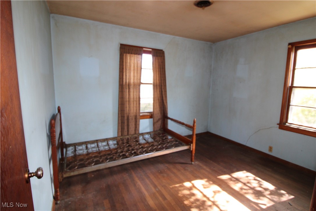 5084 West Fremont Road Port Clinton, OH 43452 - Photo 16 of 19 Empty room featuring dark wood-style floors and baseboards