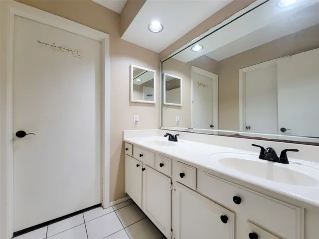 a bathroom with a double vanity sink and mirror