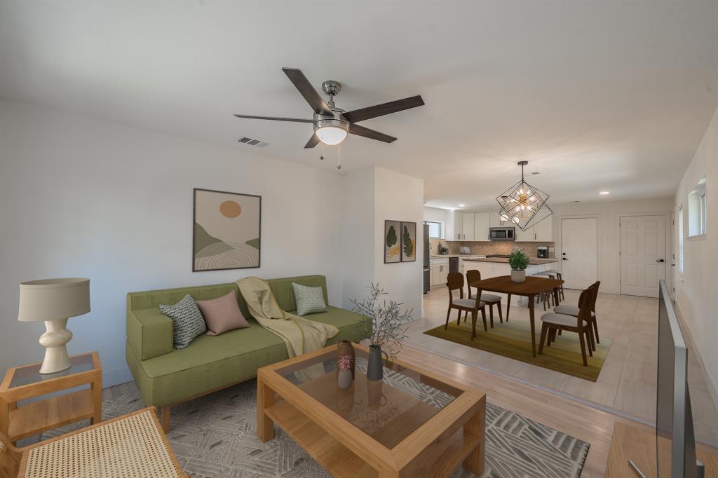 3031 Woodwind Lane Dallas, TX 75229 - Photo 11 of 29 a living room with furniture a rug and a chandelier