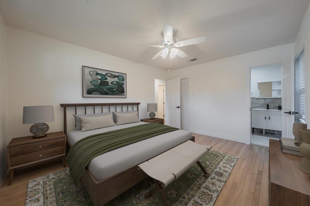 3031 Woodwind Lane Dallas, TX 75229 - Photo 13 of 29 a bedroom with a large bed and a chandelier