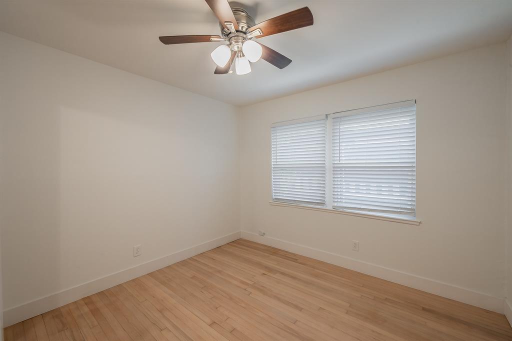 3031 Woodwind Lane Dallas, TX 75229 - Photo 15 of 29 an empty room with a window and a fan
