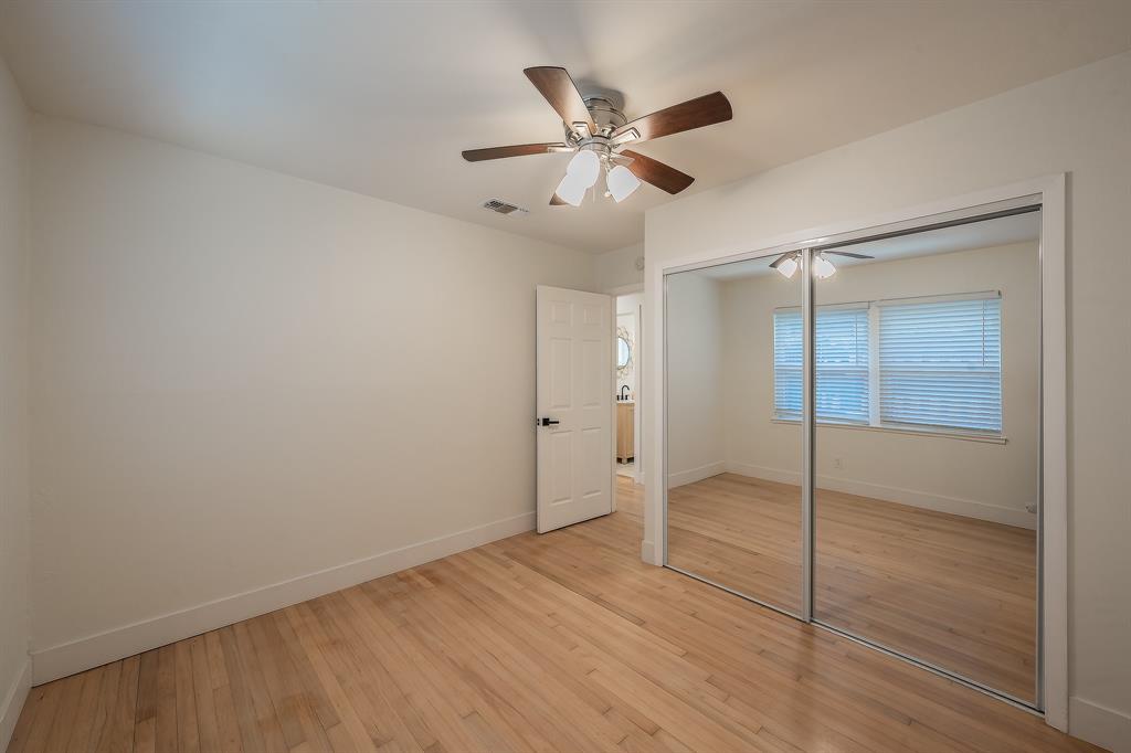 3031 Woodwind Lane Dallas, TX 75229 - Photo 16 of 29 a view of an empty room and window with a ceiling fan