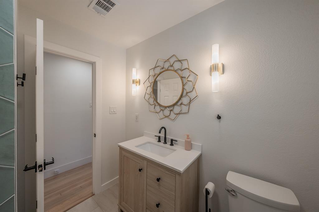 3031 Woodwind Lane Dallas, TX 75229 - Photo 21 of 29 a bathroom with a sink a toilet and shower