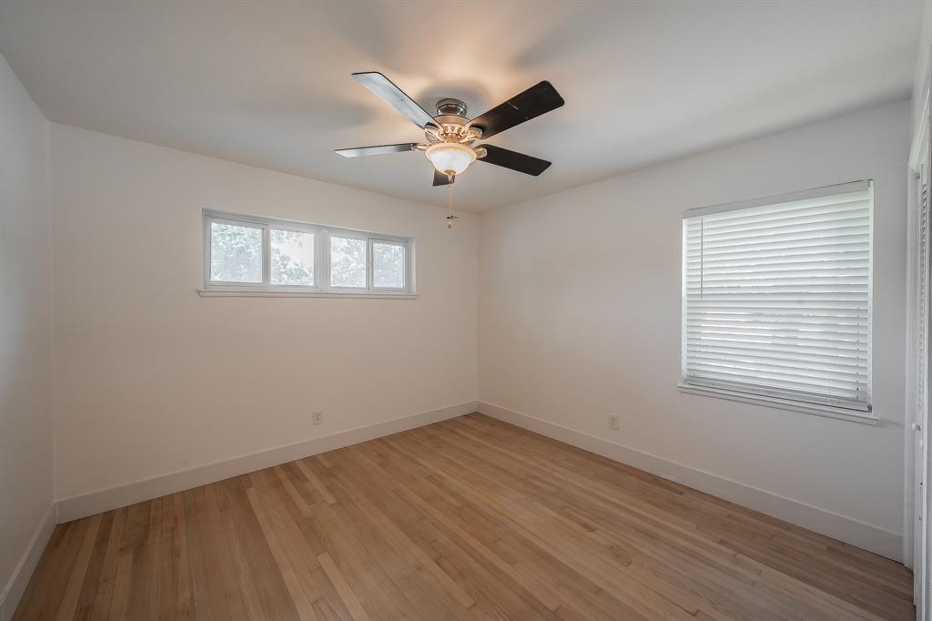 3031 Woodwind Lane Dallas, TX 75229 - Photo 22 of 29 a view of empty room with wooden floor and fan