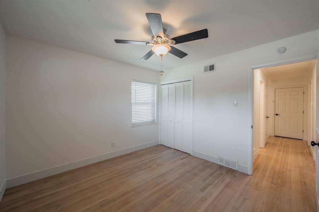 3031 Woodwind Lane Dallas, TX 75229 - Photo 23 of 29 wooden floor in an empty room with a window