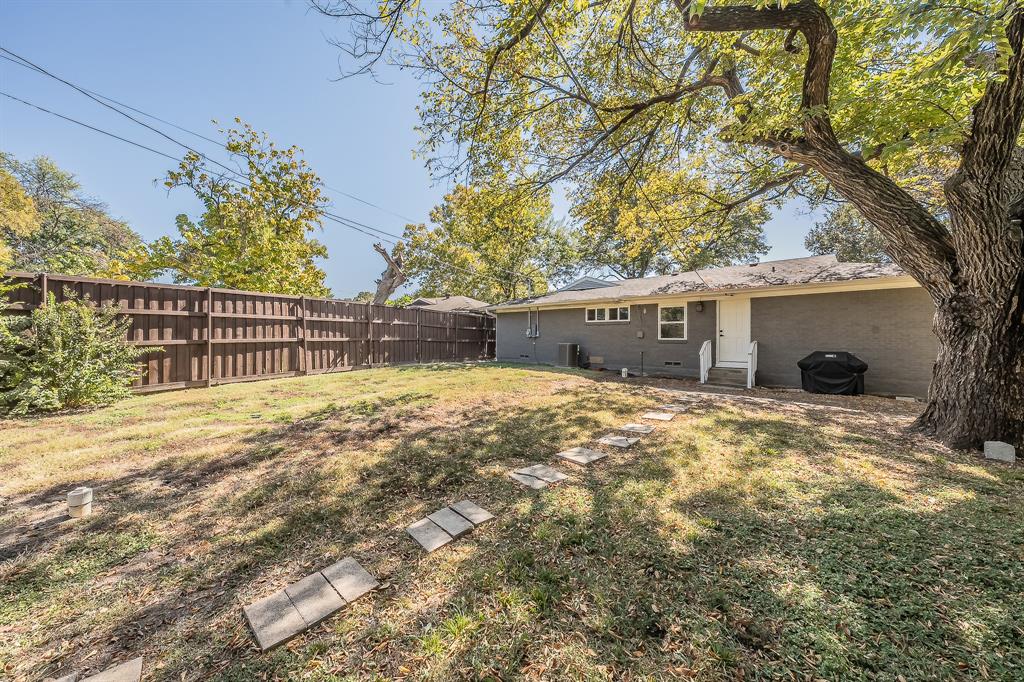 3031 Woodwind Lane Dallas, TX 75229 - Photo 28 of 29 a view of a house with a yard and tree