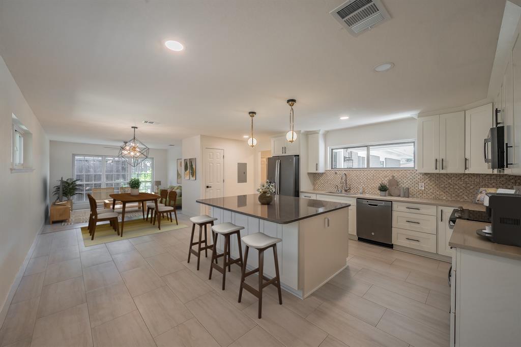 3031 Woodwind Lane Dallas, TX 75229 - Photo 4 of 29 a kitchen with counter space dining table and chairs