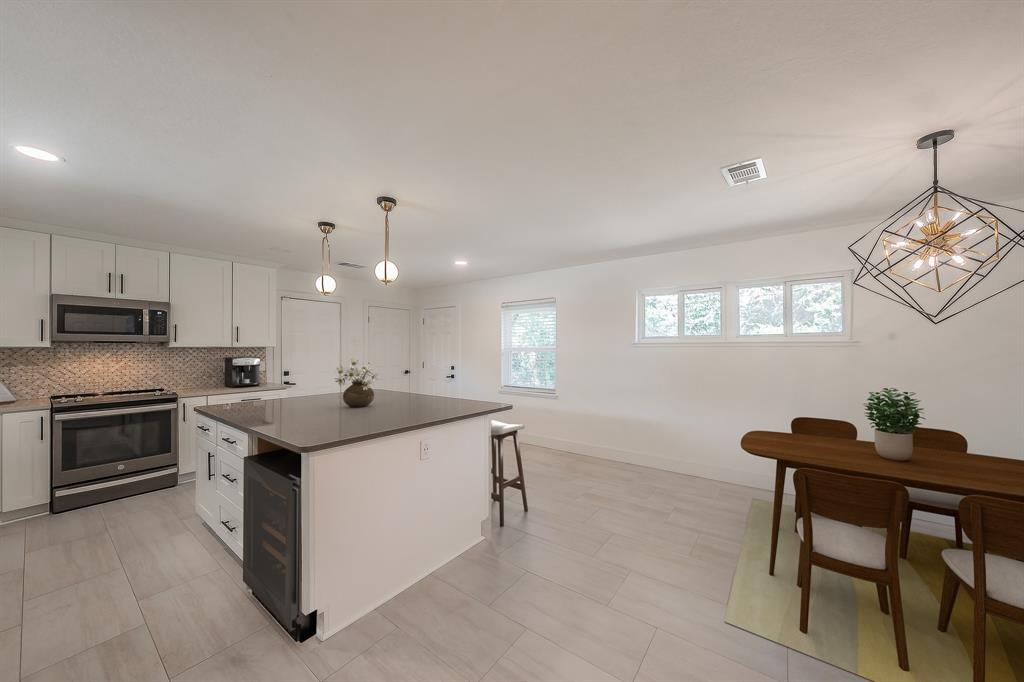 3031 Woodwind Lane Dallas, TX 75229 - Photo 5 of 29 a kitchen with a sink stove and microwave