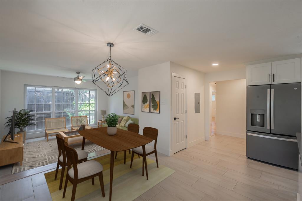3031 Woodwind Lane Dallas, TX 75229 - Photo 8 of 29 a dining room with furniture a chandelier and window