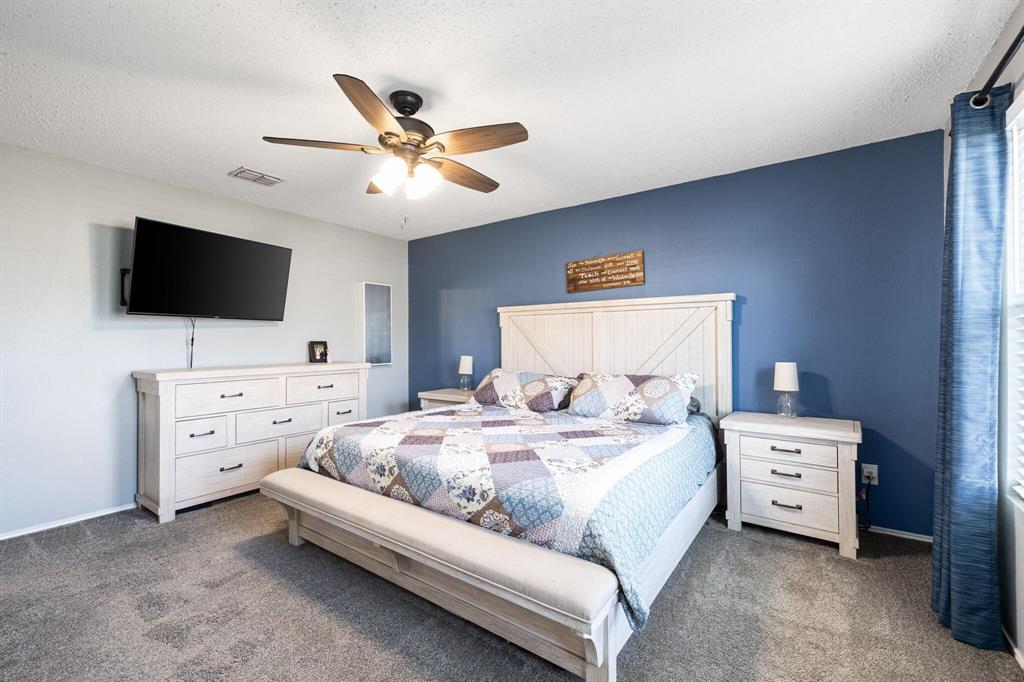 2705 Mitchell Lane Anna, TX 75409 - Photo 13 of 24 a bedroom with a bed and a flat screen tv