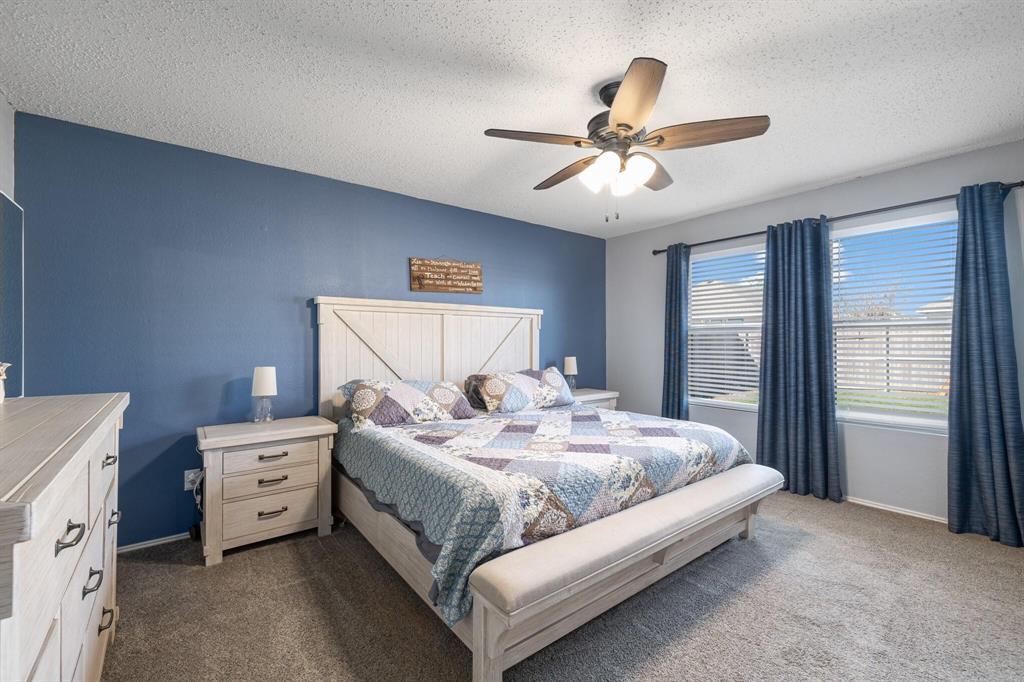 2705 Mitchell Lane Anna, TX 75409 - Photo 14 of 24 a bedroom with a bed and a chandelier