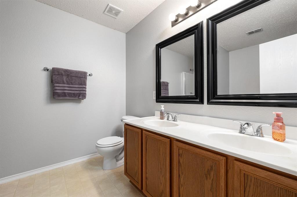 2705 Mitchell Lane Anna, TX 75409 - Photo 17 of 24 a bathroom with a toilet sink and mirror