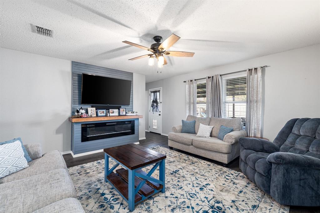2705 Mitchell Lane Anna, TX 75409 - Photo 4 of 24 a living room with furniture and a flat screen tv