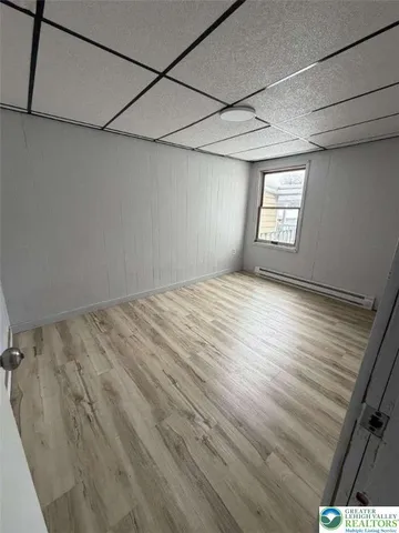 a view of a room with wooden floor