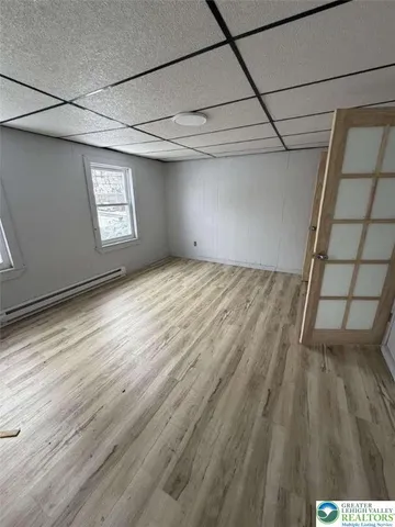 a view of empty room with wooden floor