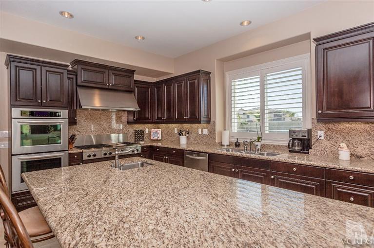 7351 Sarazen Drive Moorpark, CA 93021 - Photo 12 of 39 a kitchen with stainless steel appliances granite countertop a stove a sink and a microwave