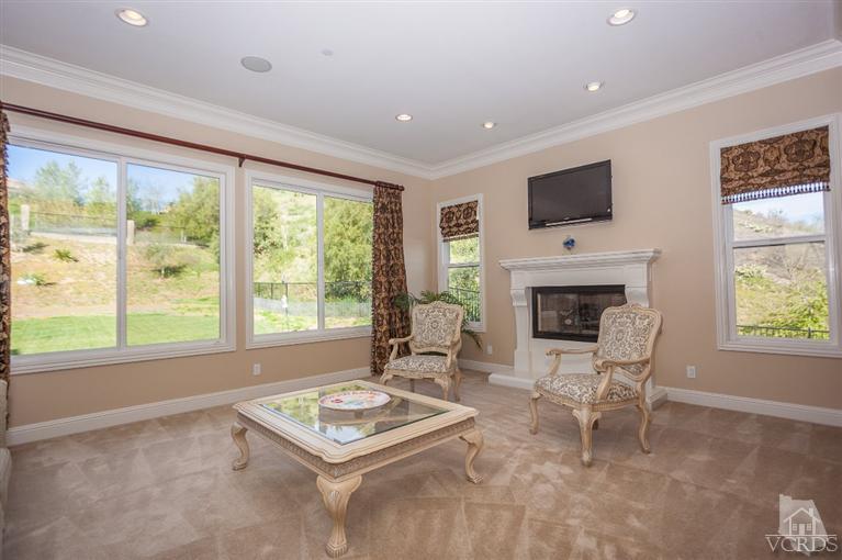 7351 Sarazen Drive Moorpark, CA 93021 - Photo 14 of 39 a living room with furniture a flat screen tv and a fireplace