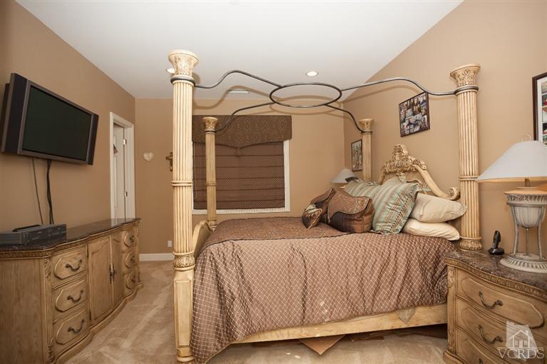 7351 Sarazen Drive Moorpark, CA 93021 - Photo 17 of 39 a bedroom with a bed and a flat screen tv