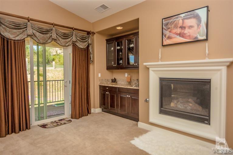 7351 Sarazen Drive Moorpark, CA 93021 - Photo 22 of 39 a living room with stainless steel appliances furniture a fireplace and a large window