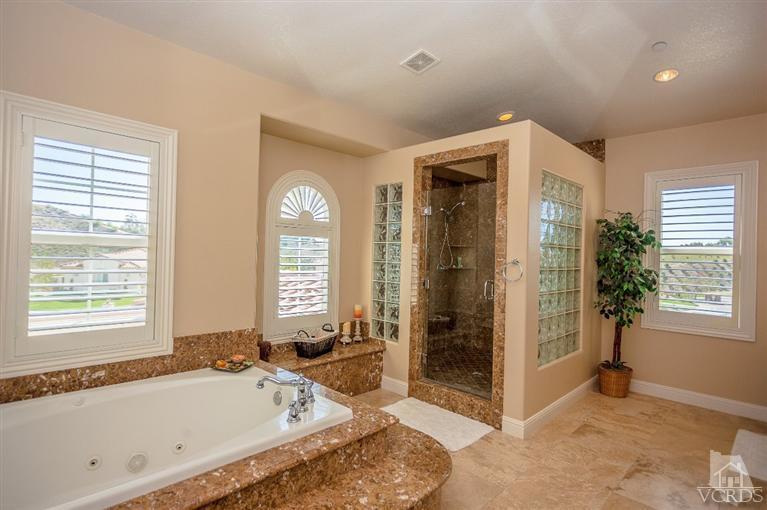 7351 Sarazen Drive Moorpark, CA 93021 - Photo 24 of 39 a spacious bathroom with a tub shower and window