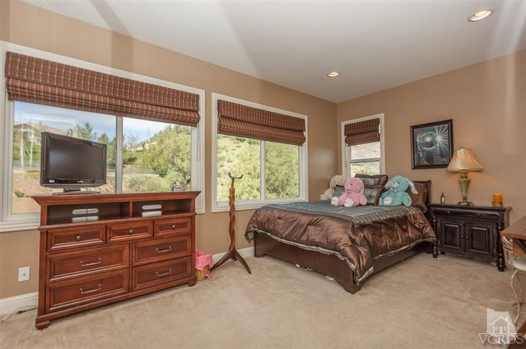 7351 Sarazen Drive Moorpark, CA 93021 - Photo 26 of 39 a living room with a bed and flat screen tv