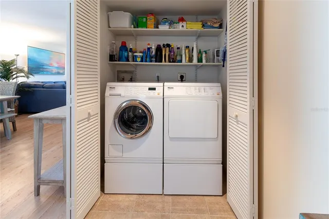 a living room with furniture large window and flat screen tv