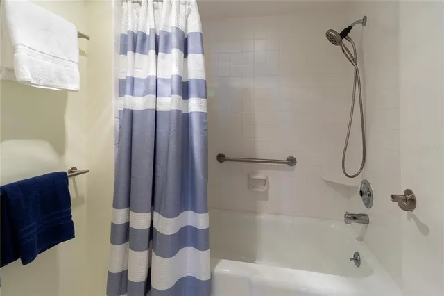 a view of a yard with plants and a large tree