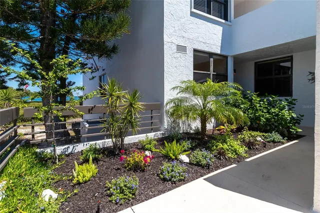 a kitchen with stainless steel appliances a sink a counter top space cabinets and a window