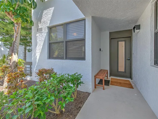 a kitchen with stainless steel appliances granite countertop a refrigerator a sink dishwasher a stove and white countertops with wooden floor