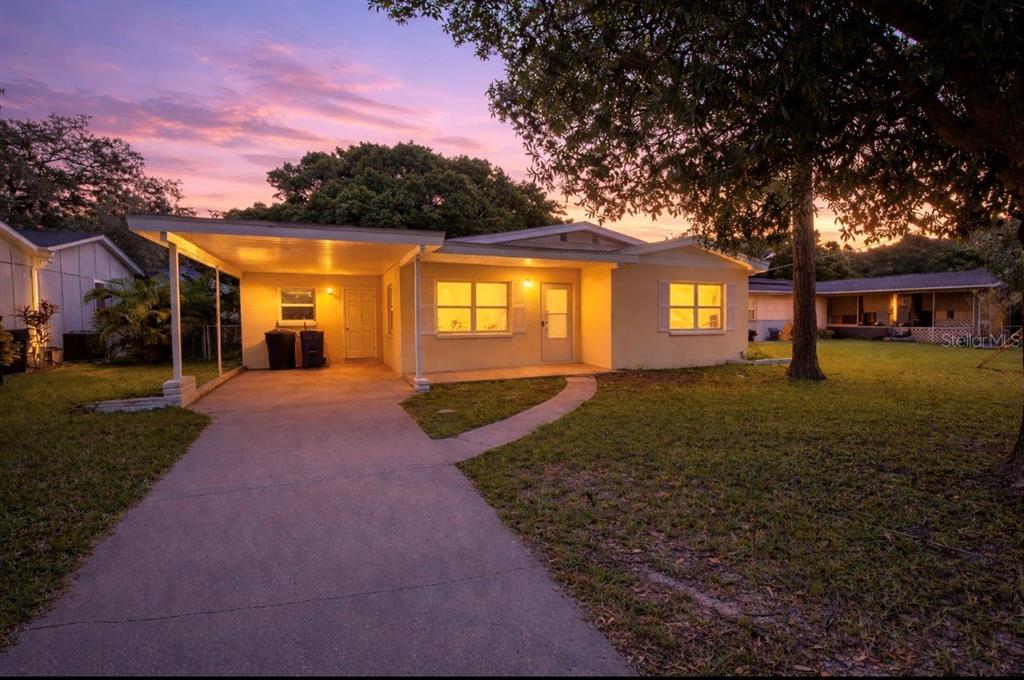 1247 Davis Road Dunedin, FL 34698 - Photo 1 of 1 a front view of a house with a yard