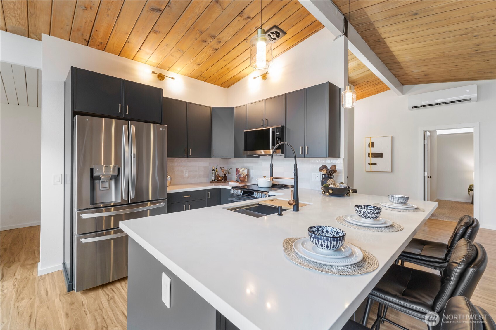 35631 13th Avenue Southwest Federal Way, WA 98023 - Photo 7 of 27 a kitchen with a sink a stove and chairs