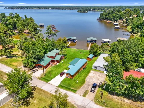 an aerial view of a house with a lake view