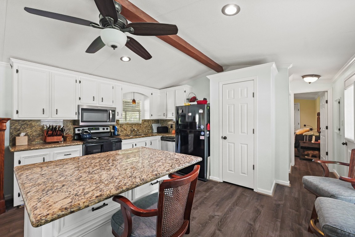 729 Lake Shore Drive Trinity, TX 75862 - Photo 14 of 38 a kitchen with stainless steel appliances kitchen island granite countertop a table chairs in it and wooden floors
