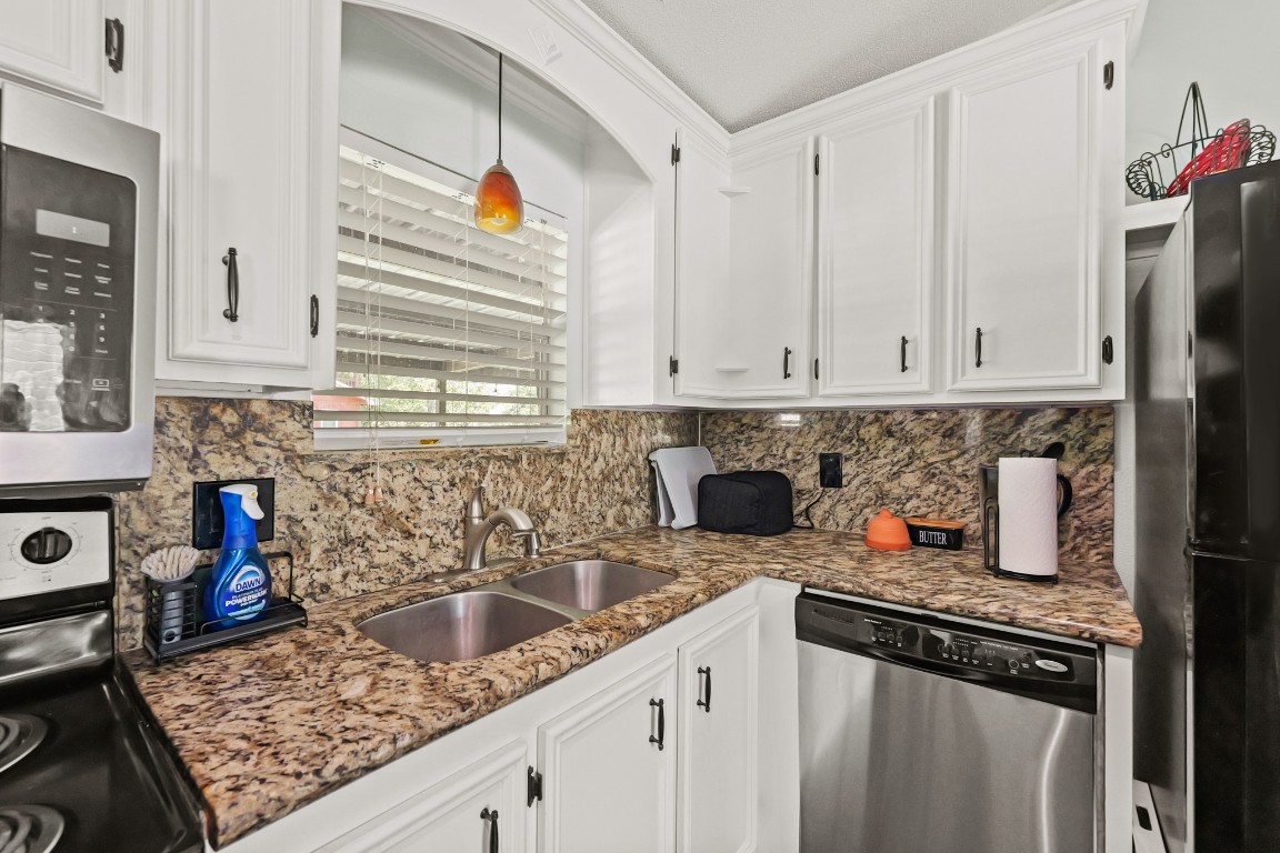 729 Lake Shore Drive Trinity, TX 75862 - Photo 17 of 38 a kitchen with stainless steel appliances granite countertop a sink stove and cabinets