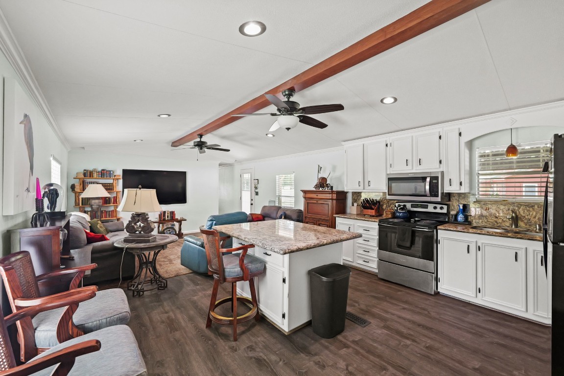 729 Lake Shore Drive Trinity, TX 75862 - Photo 19 of 38 a open kitchen with stainless steel appliances kitchen island granite countertop a sink dishwasher a stove and a refrigerator with wooden floor