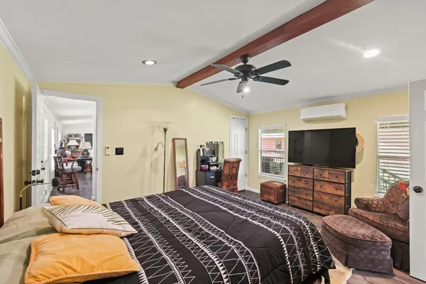 a bedroom with a bed and a flat screen tv