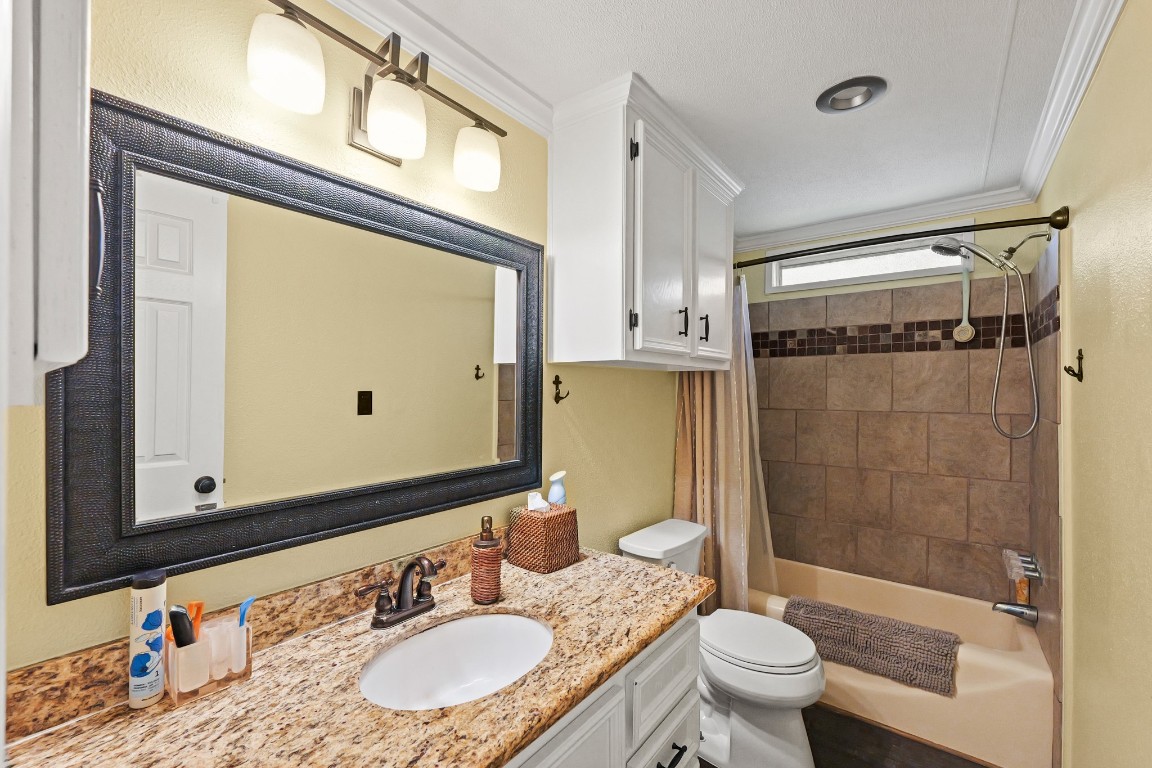 729 Lake Shore Drive Trinity, TX 75862 - Photo 24 of 38 a bathroom with a granite countertop sink toilet mirror and shower