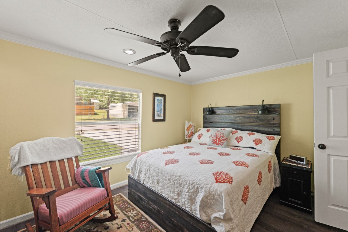 729 Lake Shore Drive Trinity, TX 75862 - Photo 25 of 38 a bedroom with a bed and wooden floor