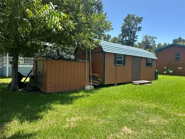 a view of backyard with cabin