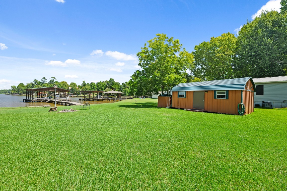 729 Lake Shore Drive Trinity, TX 75862 - Photo 5 of 38 a view of a house with backyard sitting area and garden