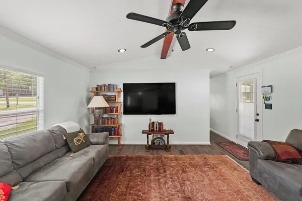 a living room with furniture and a flat screen tv