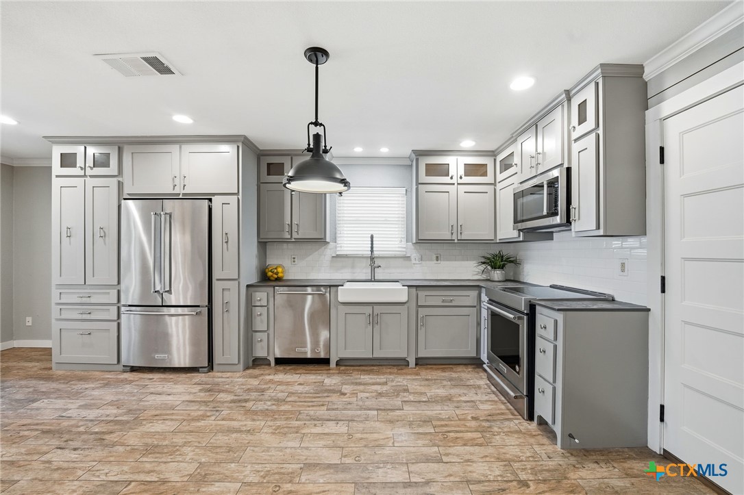 3624 Fox Run Schertz, TX 78108 - Photo 11 of 46 a kitchen with stainless steel appliances granite countertop a refrigerator a stove a sink and a refrigerator