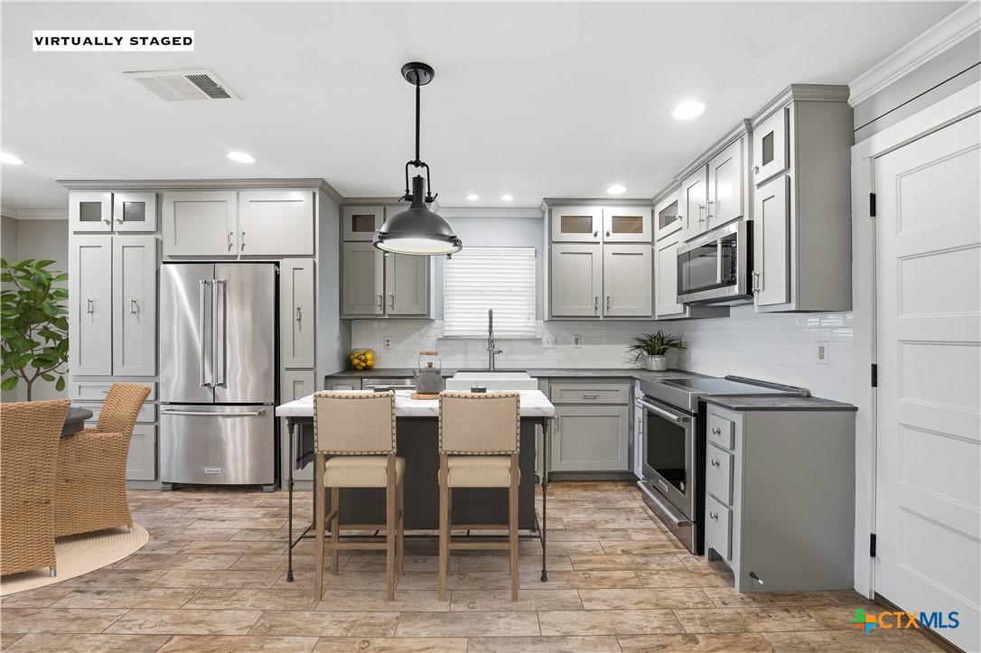 3624 Fox Run Schertz, TX 78108 - Photo 12 of 46 a kitchen with stainless steel appliances granite countertop a refrigerator a stove top oven a sink dishwasher and white cabinets