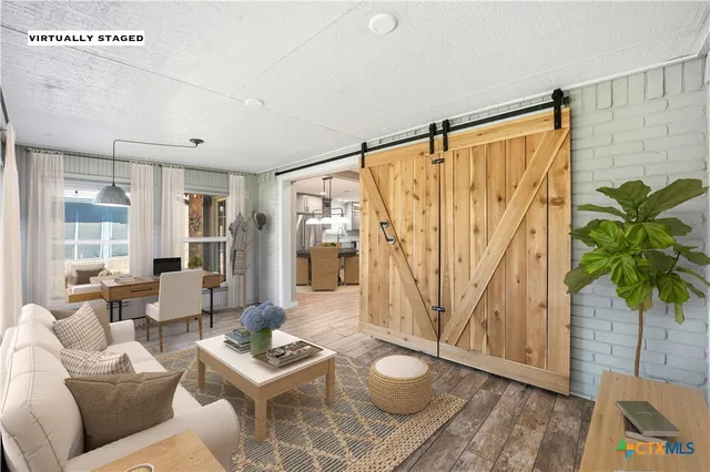 a living room with furniture and a potted plant