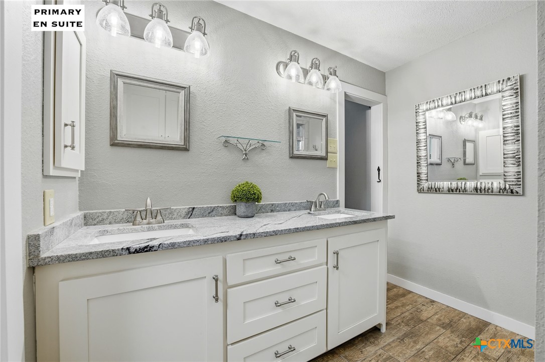 3624 Fox Run Schertz, TX 78108 - Photo 18 of 46 a bathroom with a granite countertop double vanity sink and a mirror